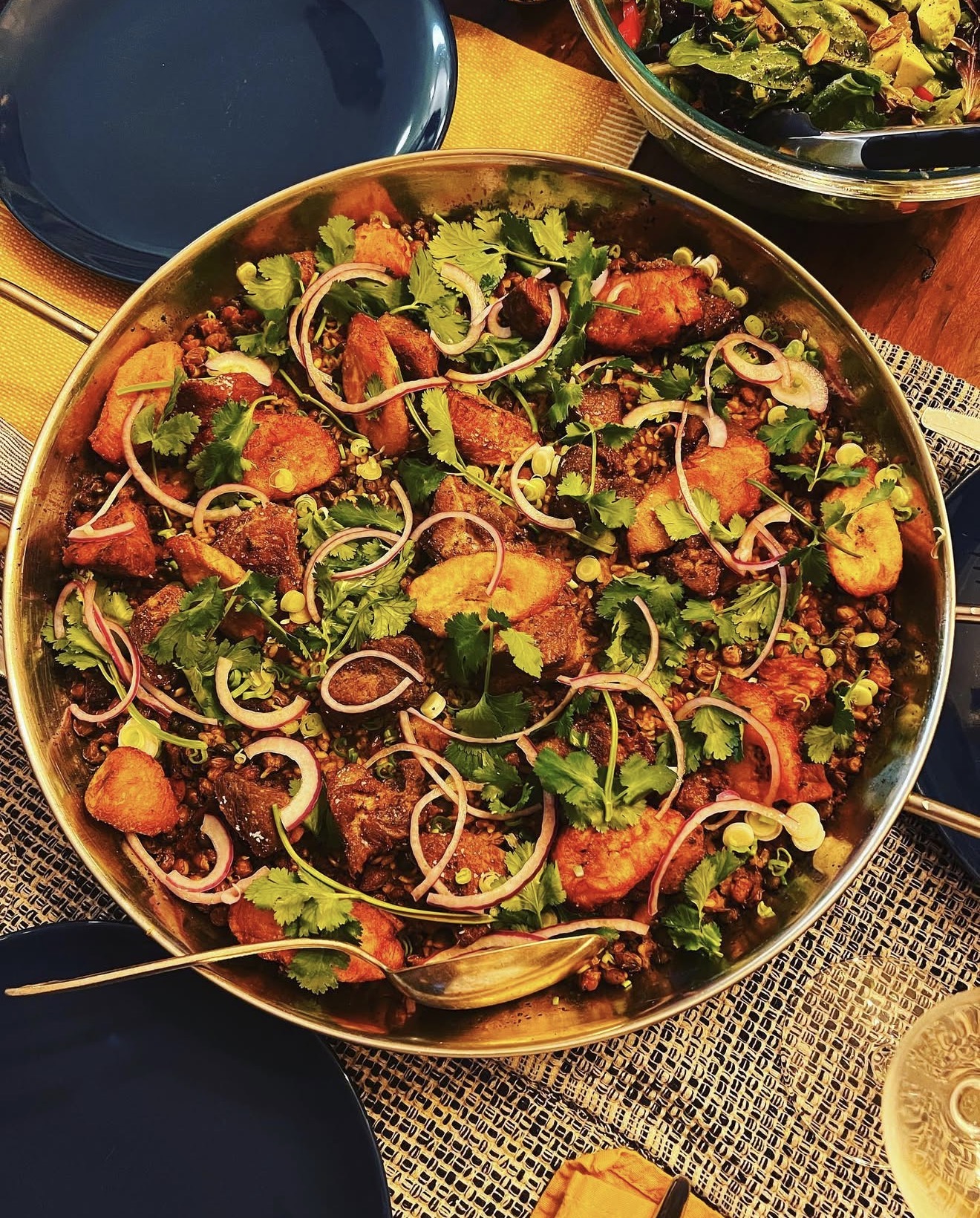 Nolo's signature paella — sweet plantain, cilantro, and slow-cooked rice